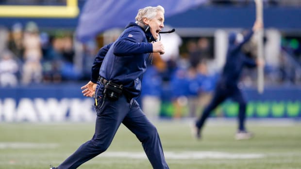Seattle Seahawks head coach Pete Carroll runs onto the field.